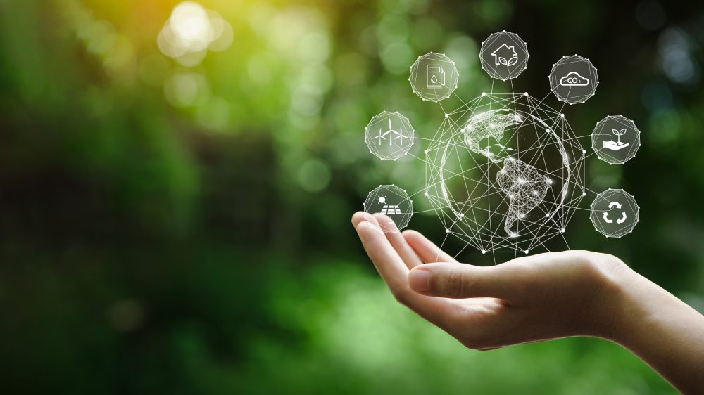 Energy Harvesting - Hand-holding with environment Icons over the Network connection on a green background to Technology and environmental protection, renewable, sustainable energy sources.